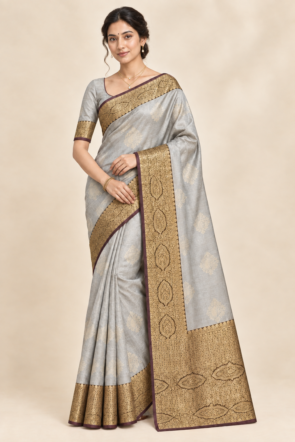 Model in silver grey saree wearing a layered gold chain necklace